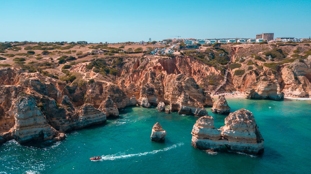 Stunning aerial shot of the rocky coastline near Lagos in the Algarve with clear blue water