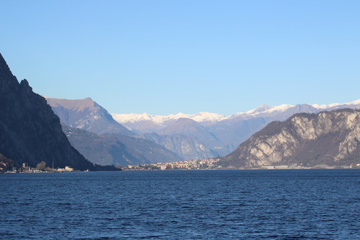 Lake Como framed by snow-capped mountains under a clear sky