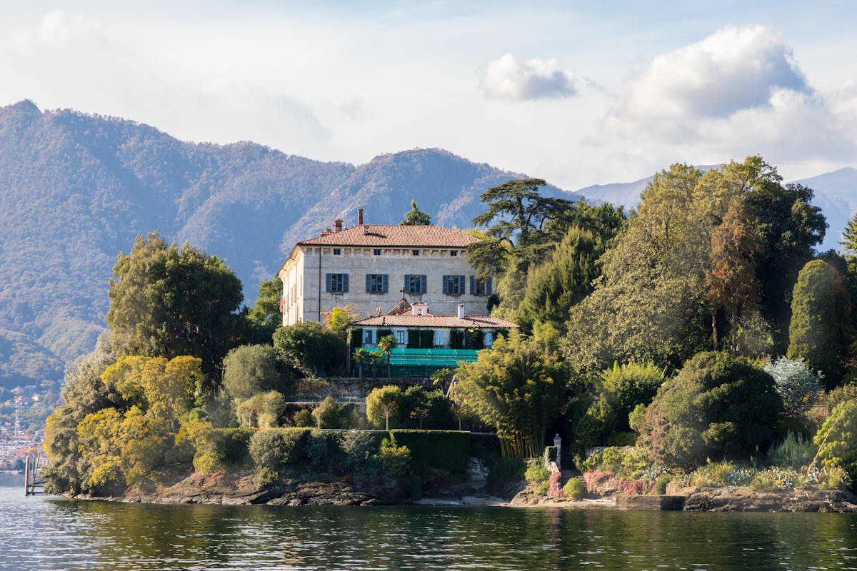 Villa on the shores of Lake Como with lush greenery and mountain views