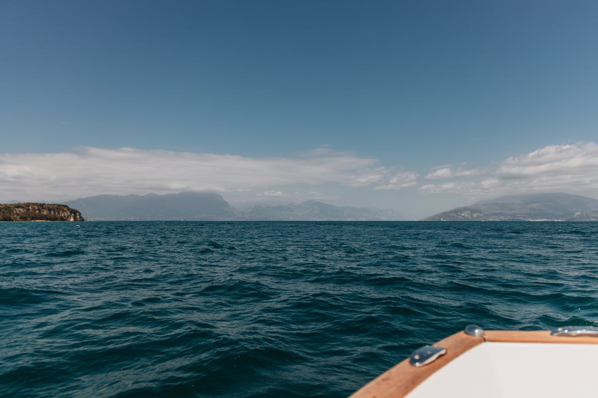 Sunny view of Lake Garda with mountains in the background