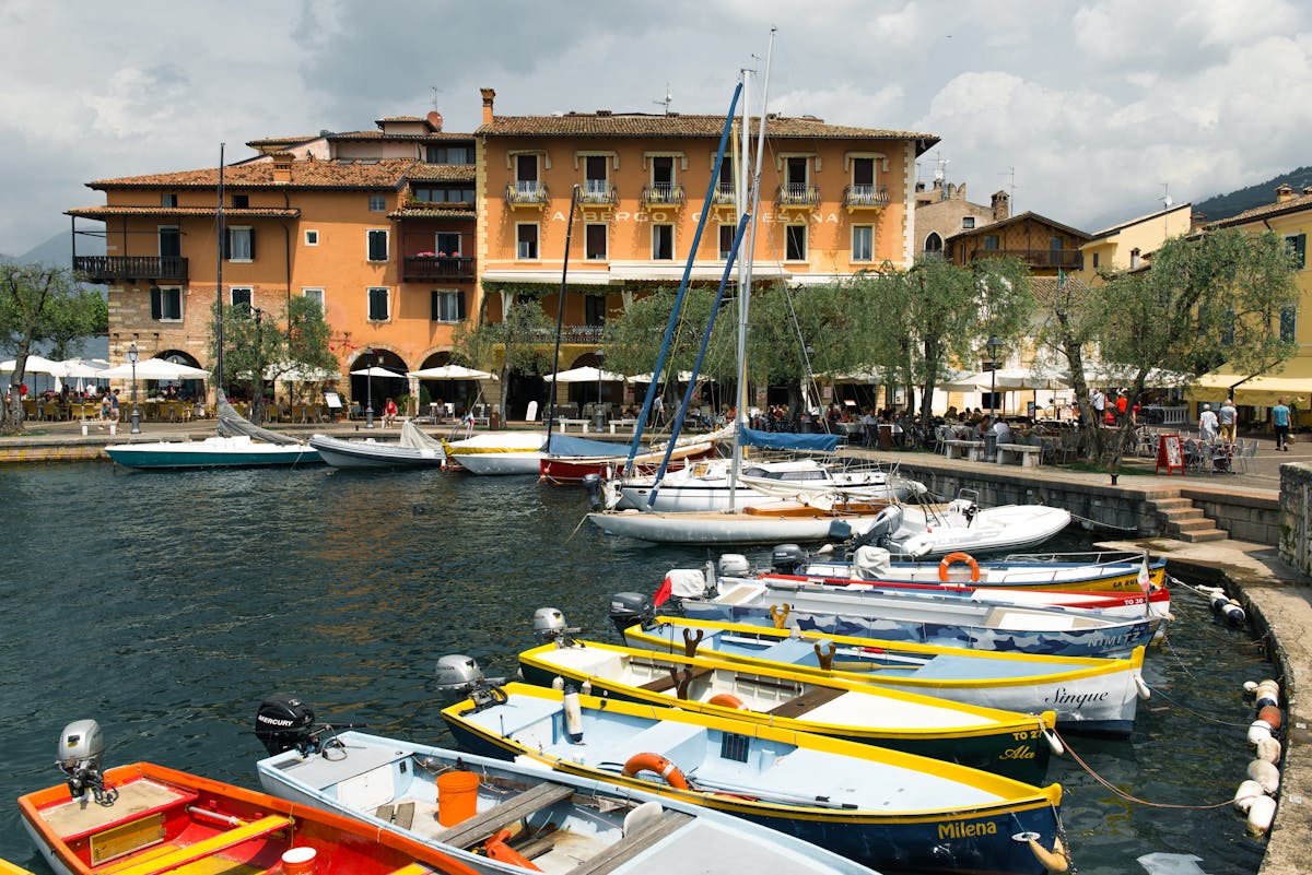 Picturesque lakeside village in Italy with colorful boats at the harbor