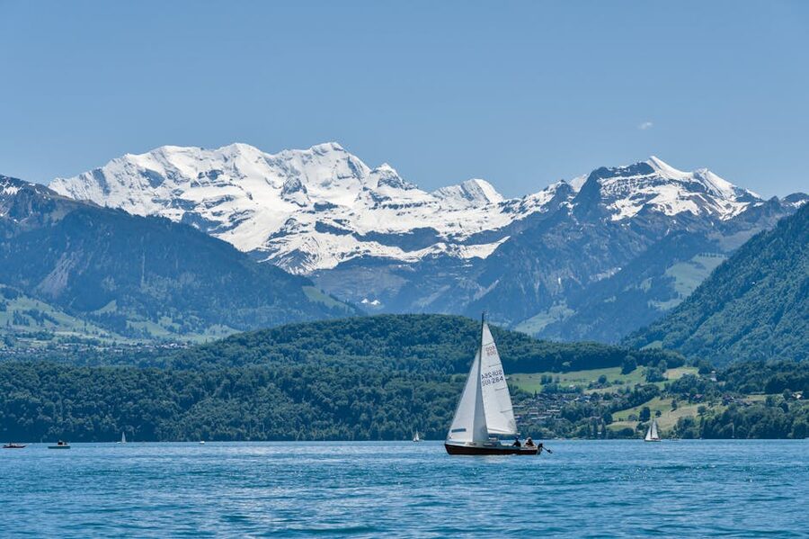 Sailboat on Lake Thun with alpine backdrop
