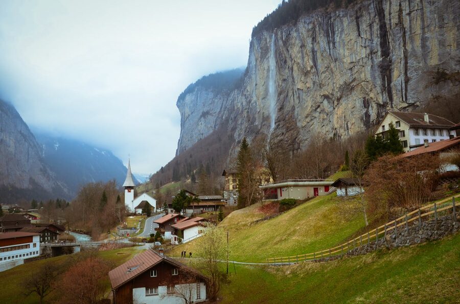 Lauterbrunnen village with waterfall and towering cliffs in Switzerland