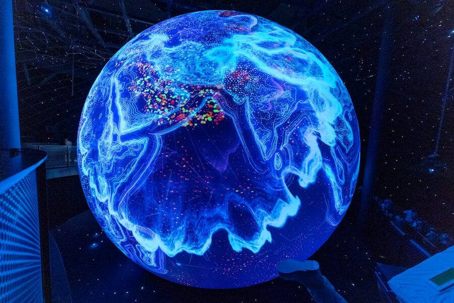 Illuminated globe display showing science and technology themes