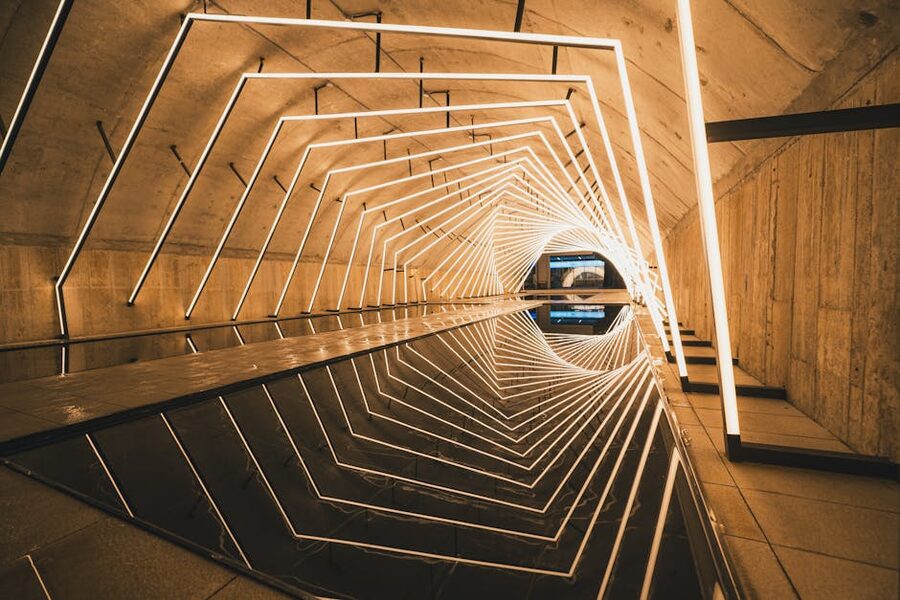 LED light tunnel with reflective surfaces creating geometric patterns
