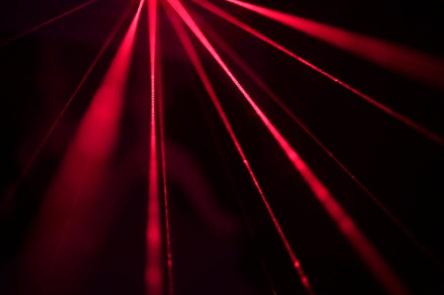 Red laser beams creating dynamic abstract patterns