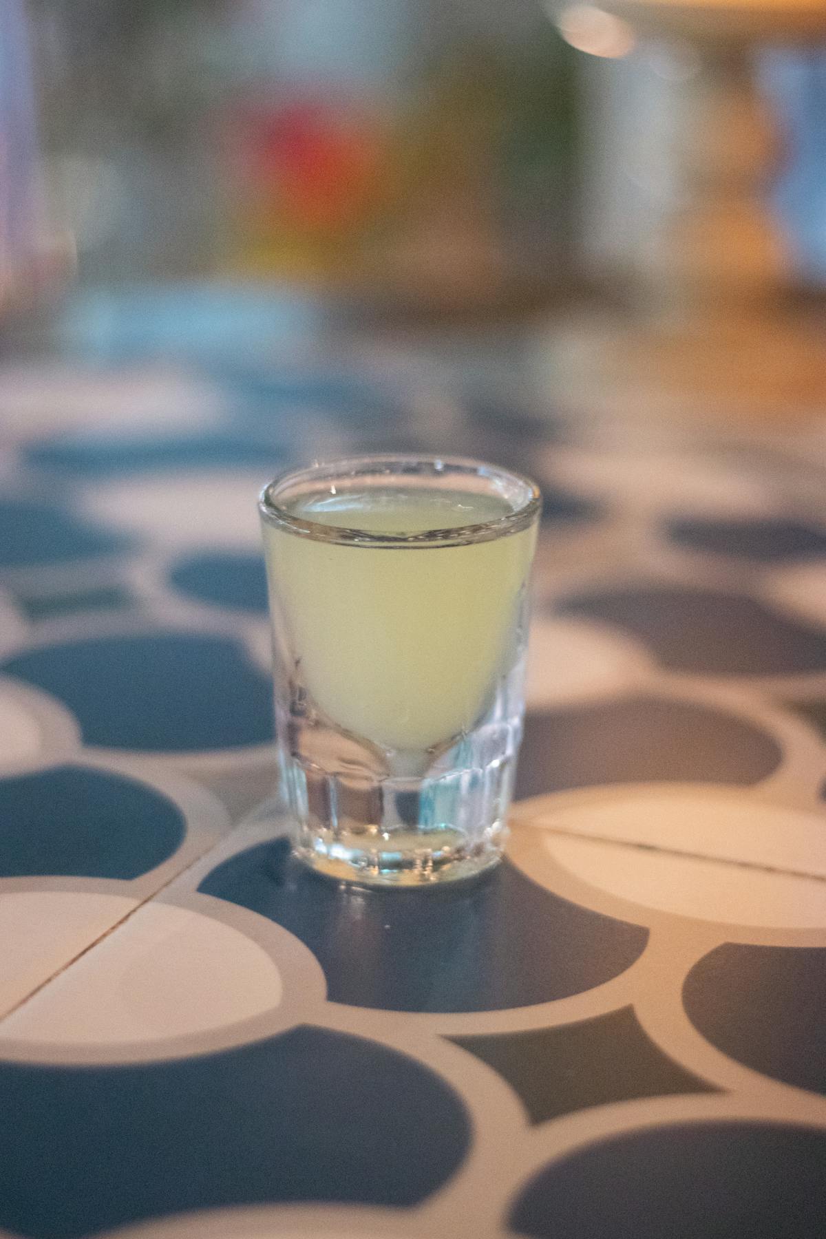 A refreshing glass of limoncello on a table at an Italian restaurant