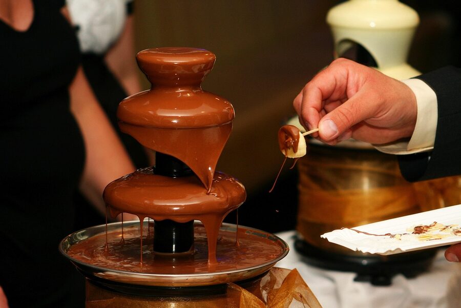 Chocolate fountain with liquid chocolate cascading down tiers