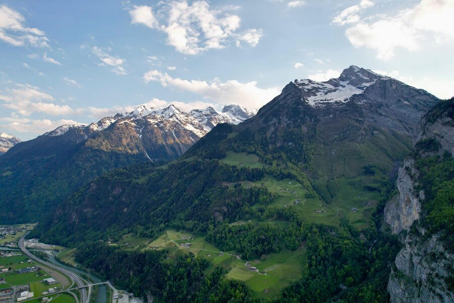 Aerial view of lush valleys and Alpine peaks in Switzerland