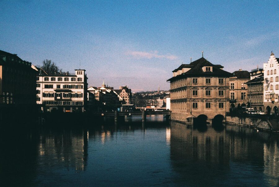 Historic charm of Zurich's waterfront buildings under a cloudy sky