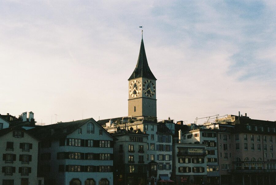 View of Zurich's St Peter's Church tower against a blue sky