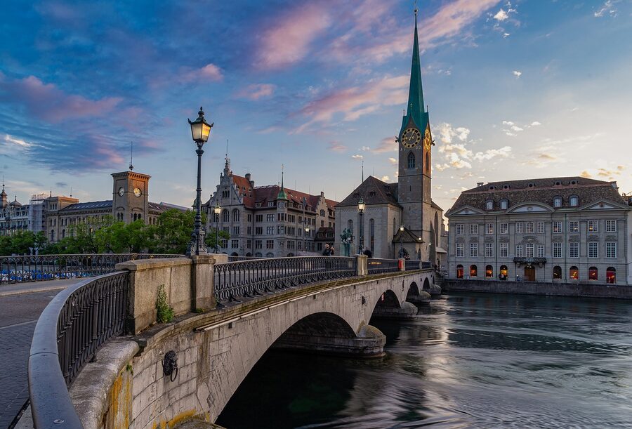 Zurich river bridge with historic city buildings and church towers