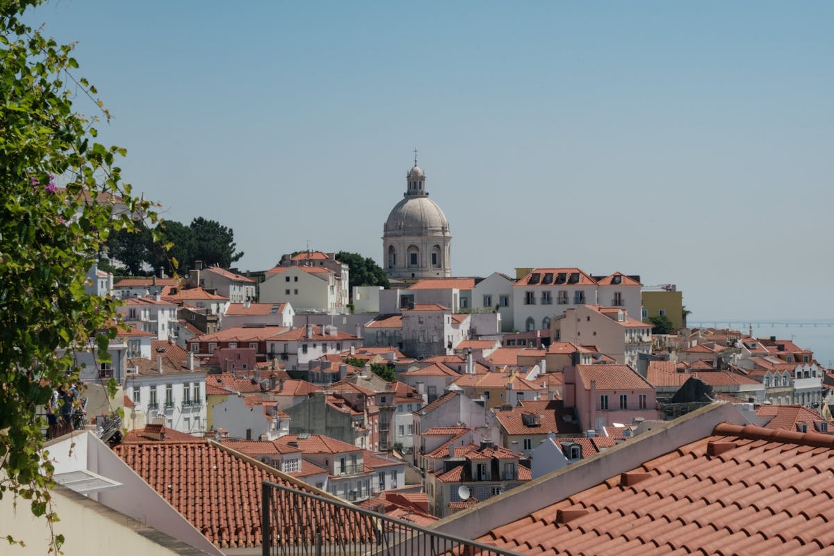 Beautiful view of Lisbon traditional red rooftops with a prominent dome in the background