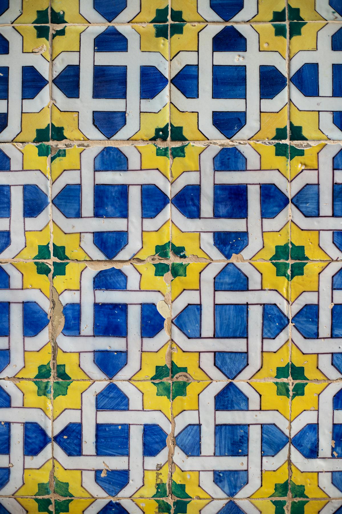 Traditional Portuguese azulejo tiles featuring geometric patterns in blue yellow and green