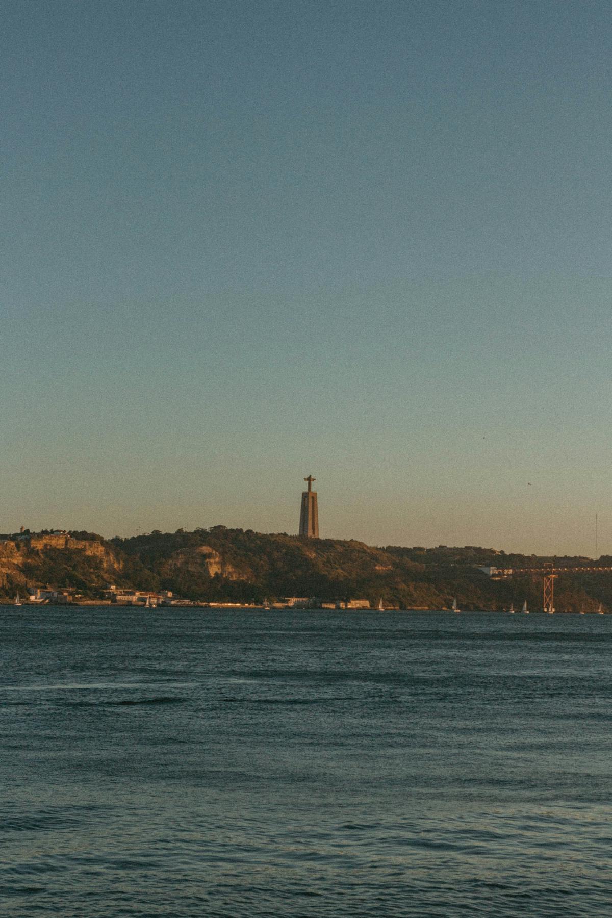 The Cristo Rei statue overlooking the Tagus River at sunset in Lisbon