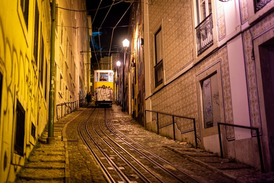 Lisbon tram at night navigating steep street