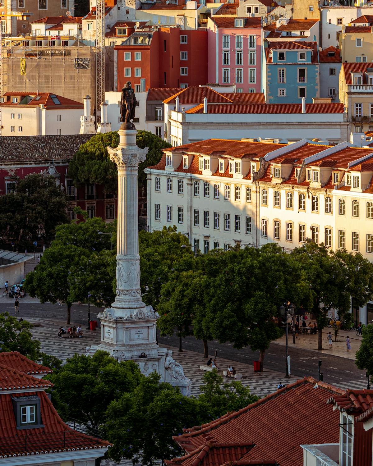 Rossio Square in Lisbon featuring colorful architecture and a historic statue