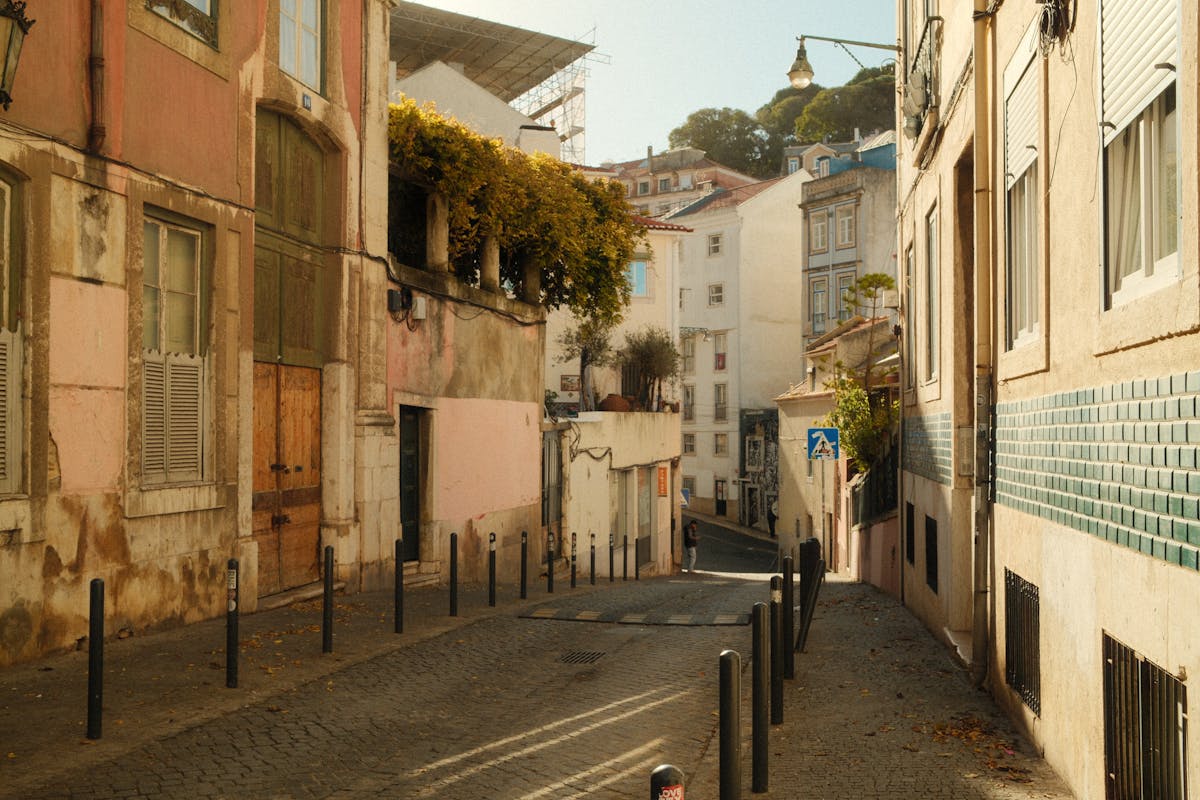 A picturesque street in Lisbon with colorful buildings and warm afternoon light