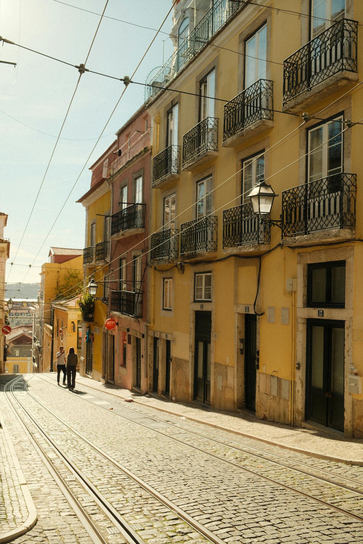 Charming Lisbon street view with historic colorful buildings and tram tracks