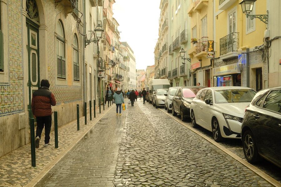 Cobblestone street in Lisbon historic district with pedestrians