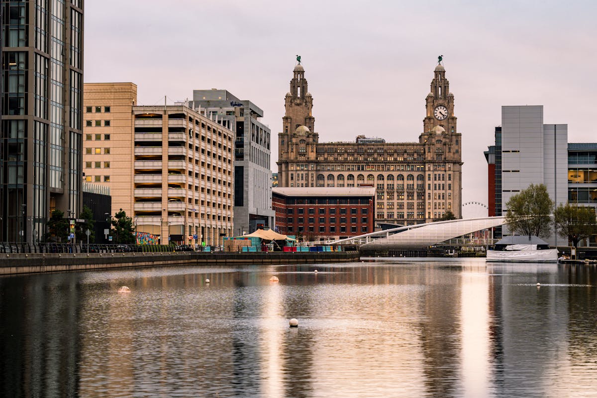 Historic Liverpool waterfront with ships and buildings reflected in the water