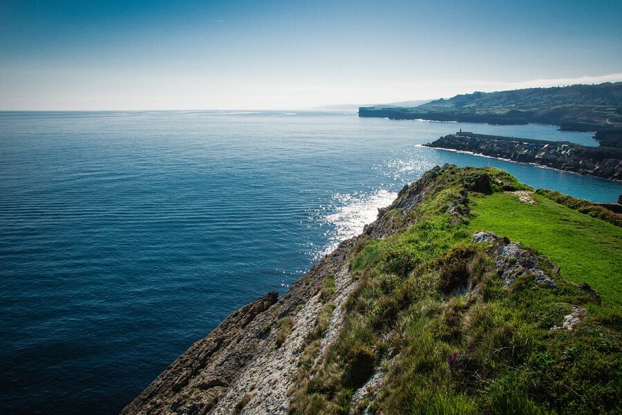 Golden hour light on the Spanish coastline with turquoise water and cliffs