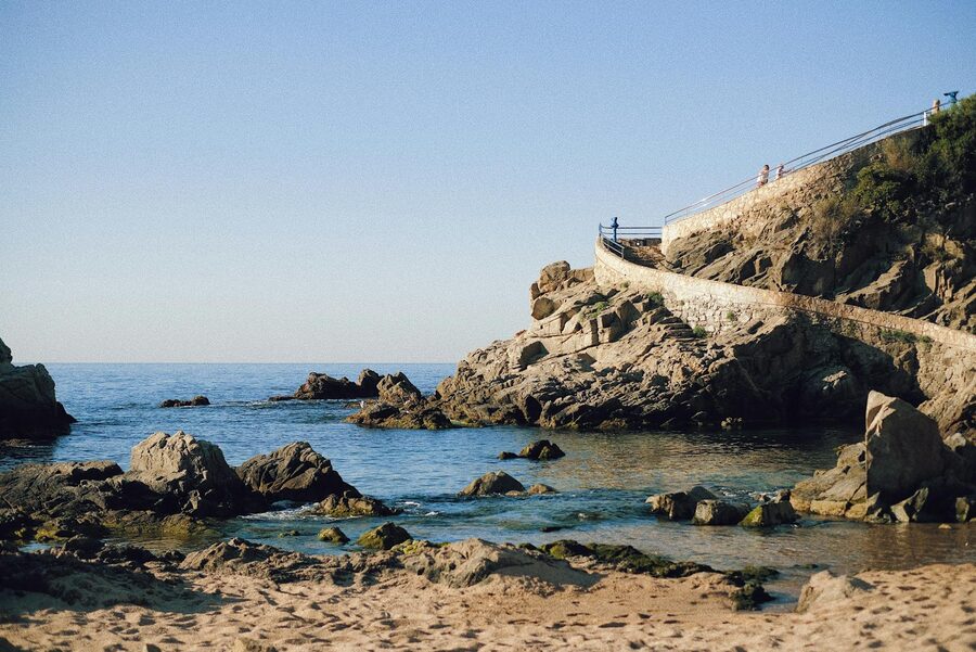 Walkway along rocky shores with Mediterranean Sea in the background