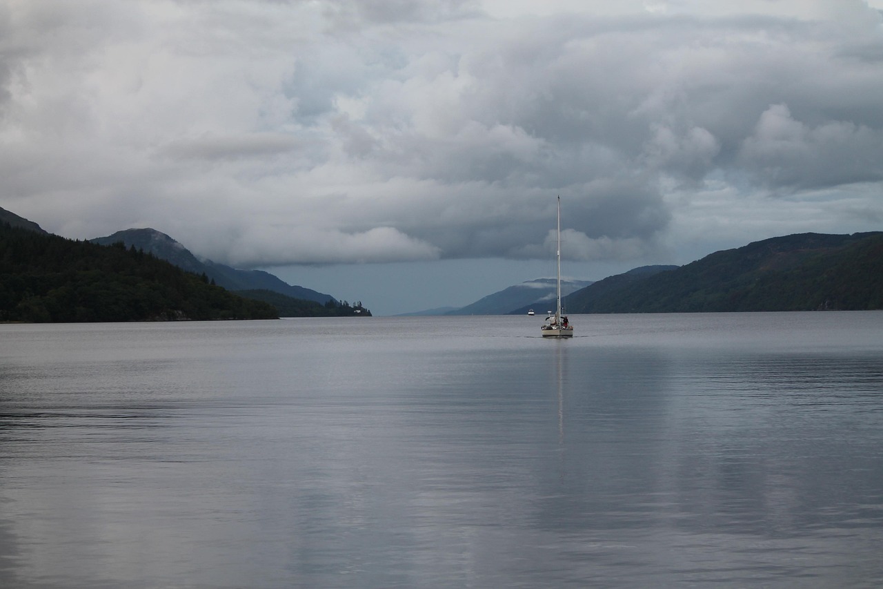 A boat moored on Loch Ness at evening with golden light on the water