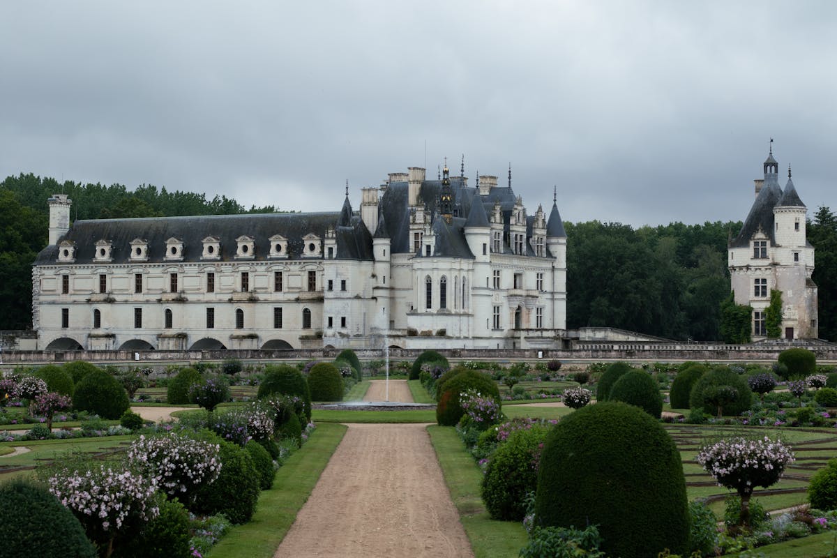 Chateau de Chenonceau with colorful formal gardens in the foreground