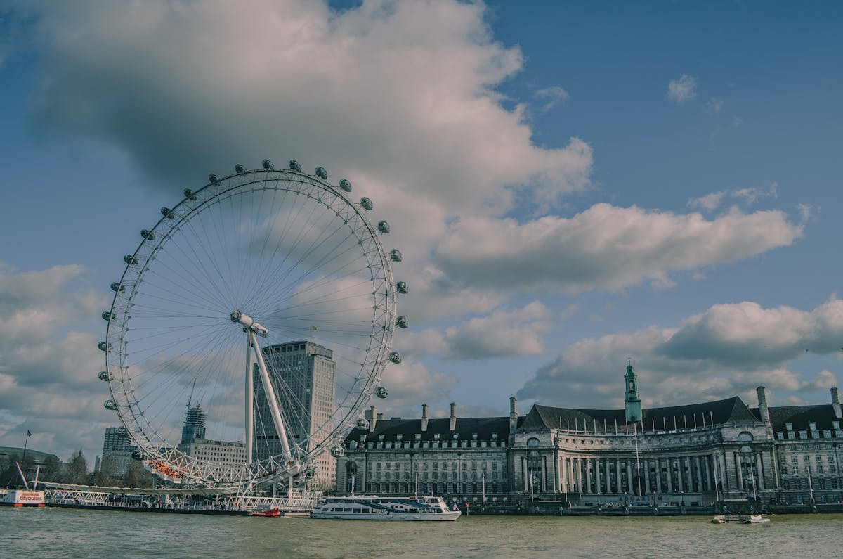 The London Eye wheel standing tall against a deep blue afternoon sky