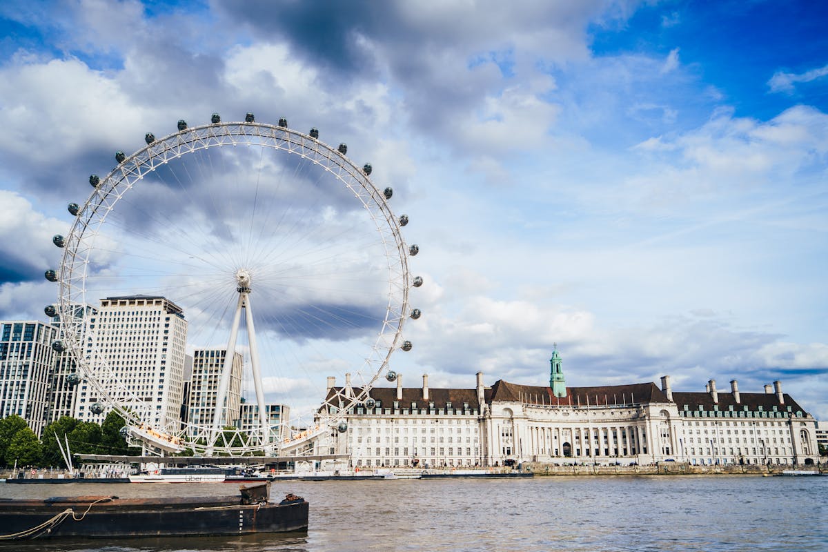 Glass pods of the London Eye with visitors inside overlooking the South Bank