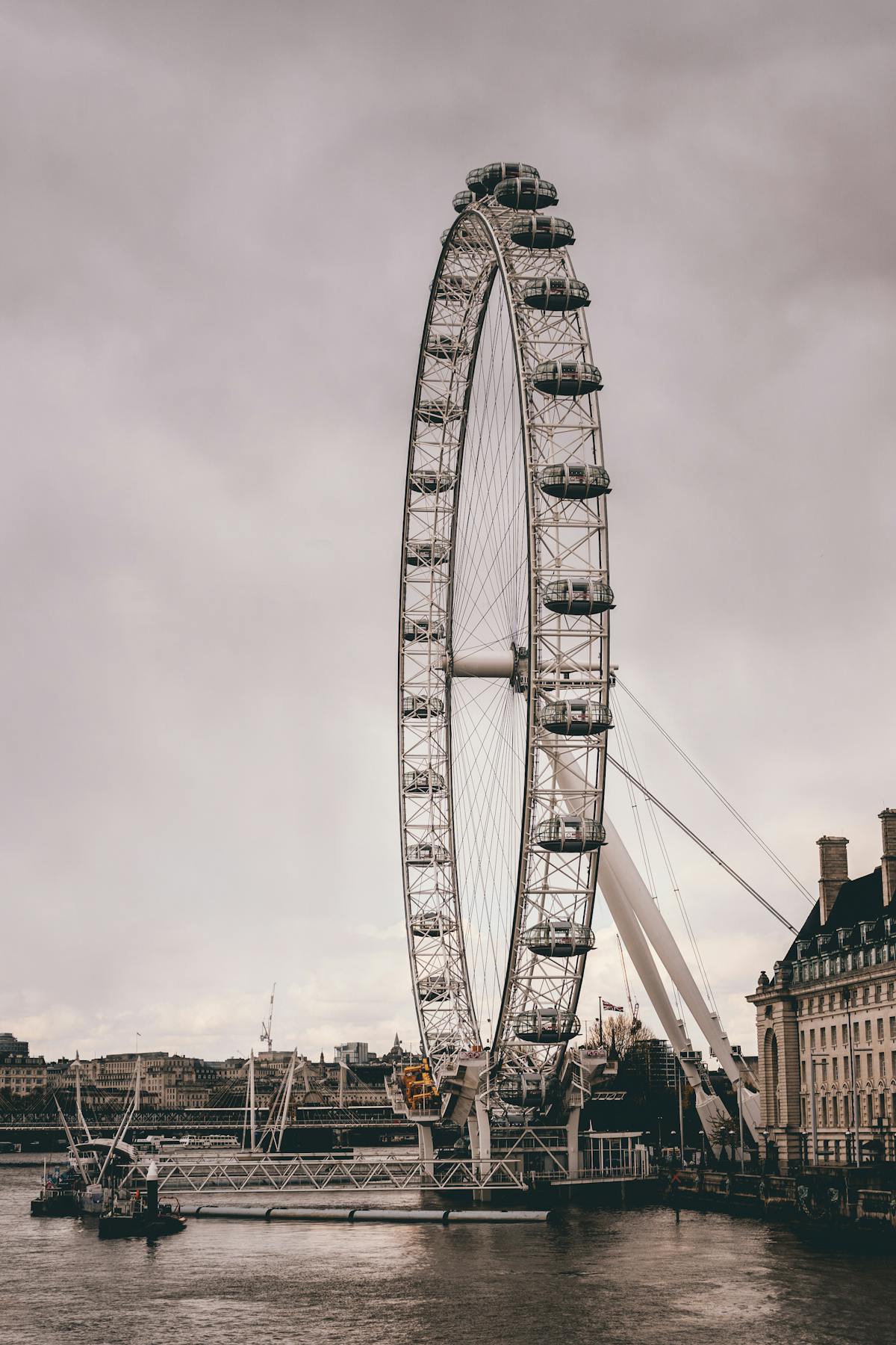 The London Eye lit up against overcast evening clouds