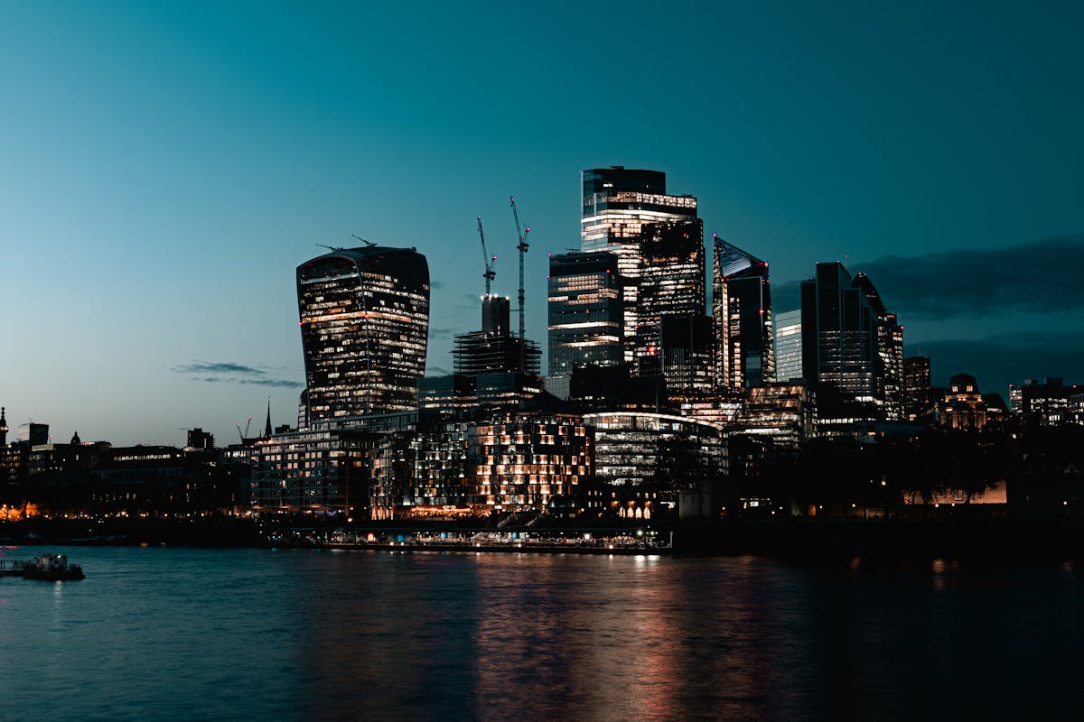 London skyline illuminated at dusk with reflections on the Thames