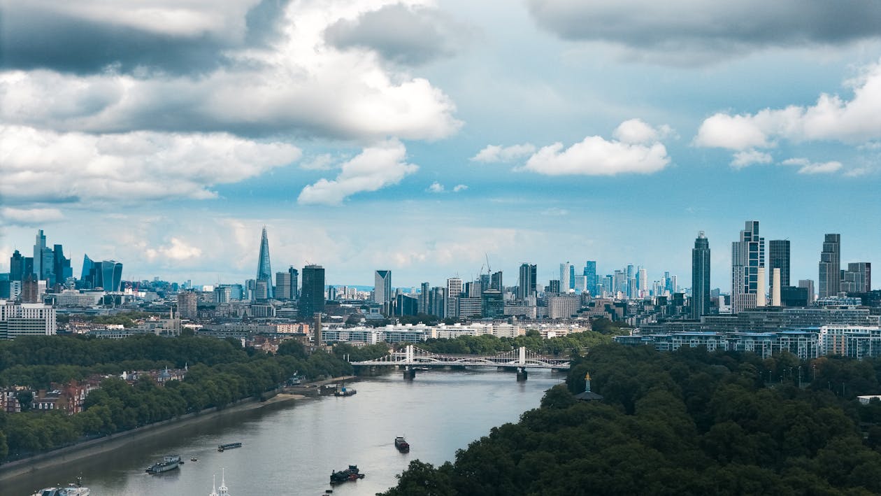 Panoramic view of London skyline with the River Thames flowing under dramatic clouds
