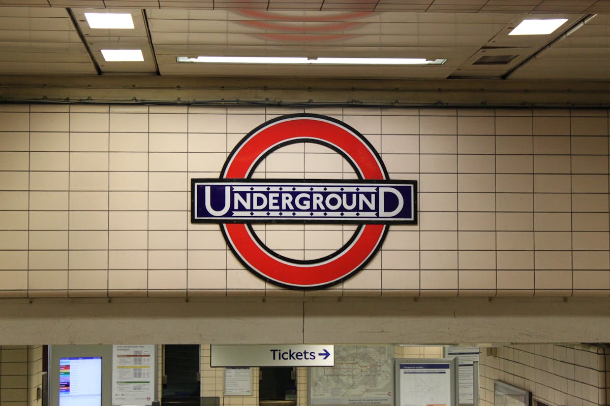 Classic London Underground roundel sign on a tiled station wall