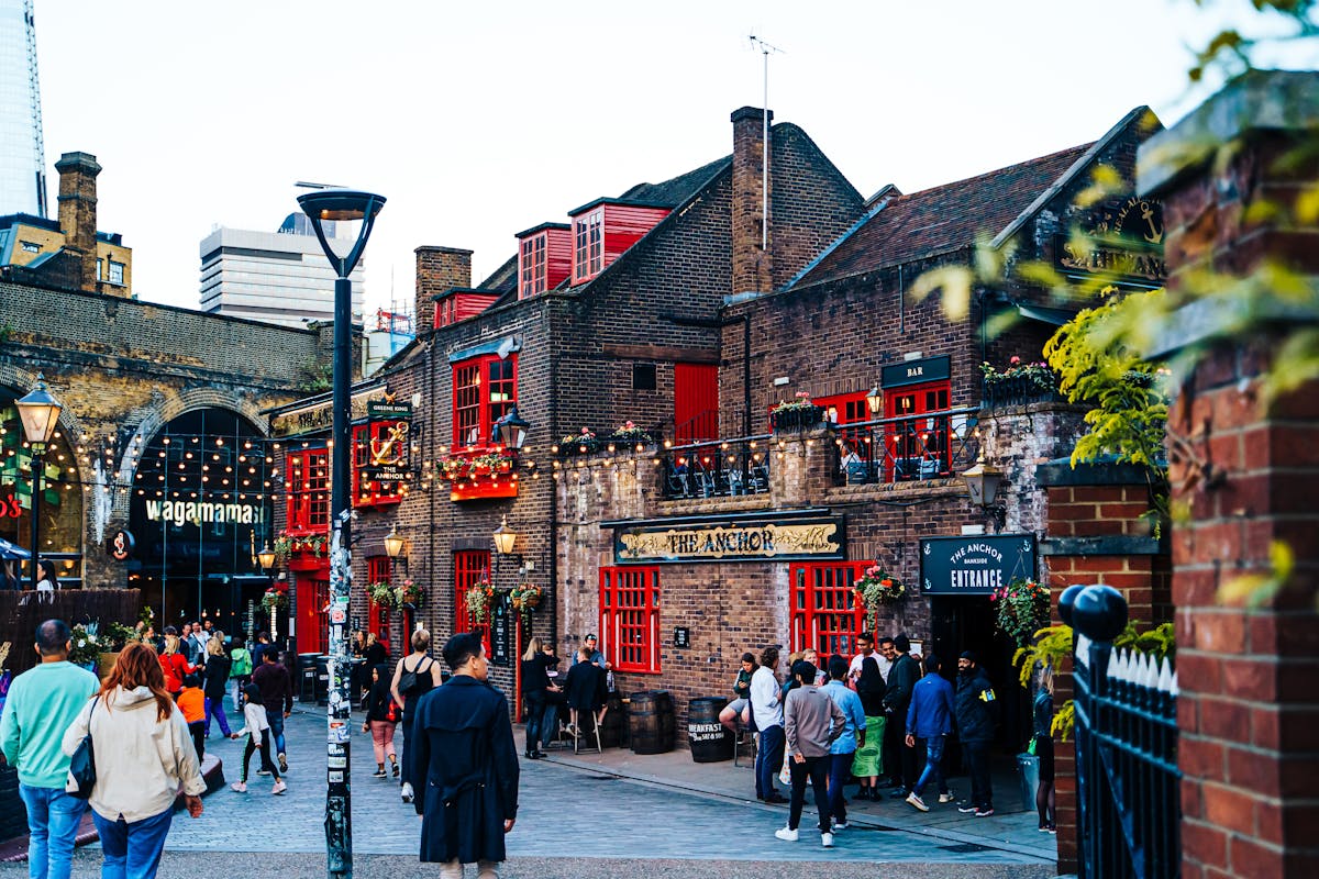 The Anchor pub in London with people gathered outside on a warm evening