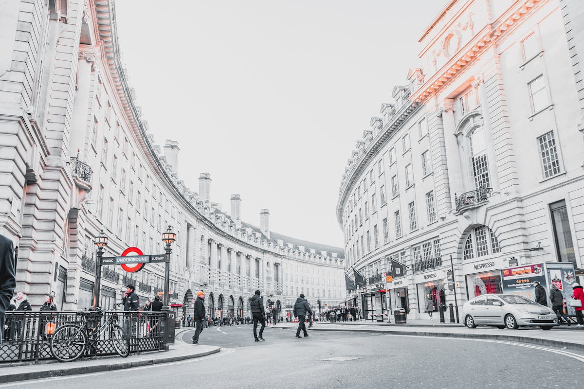Pedestrians walking along Regent Street in London with classical buildings