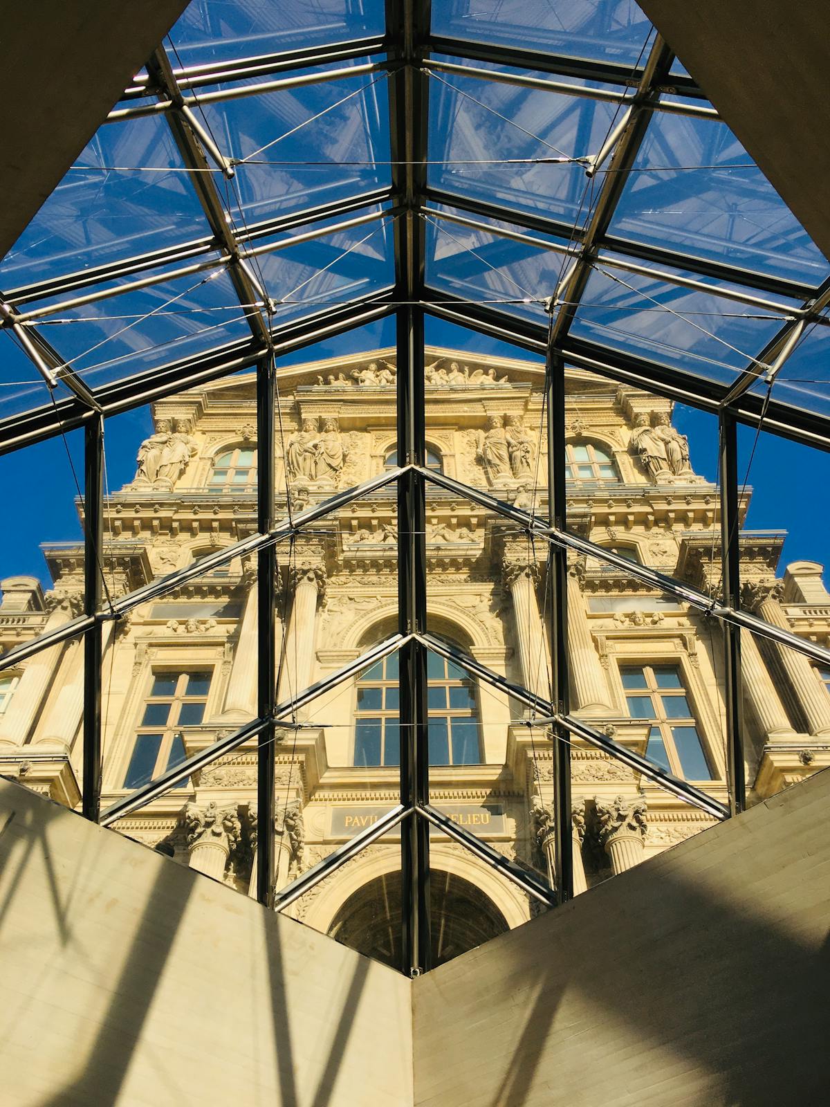Interior view looking up through the Louvre glass roof structure