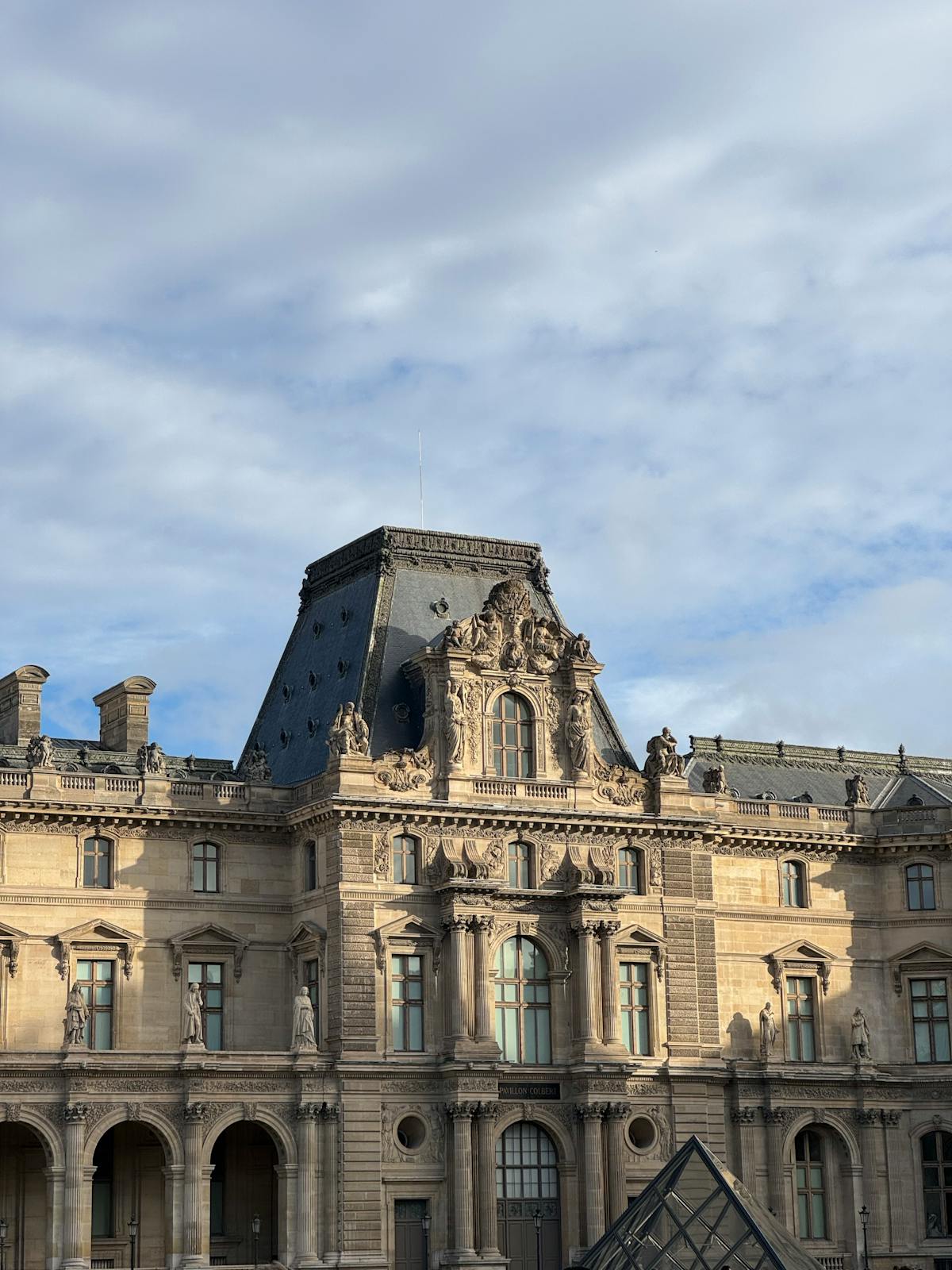 Louvre Palace exterior showing detailed French Renaissance architecture under blue sky