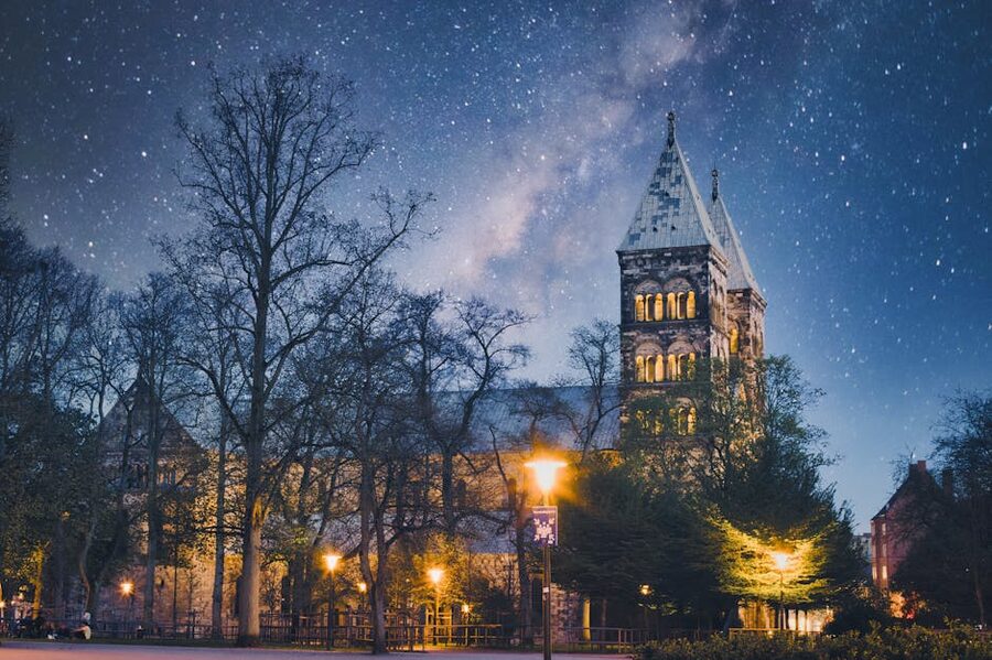 Lund Cathedral exterior lit up at night against starry sky