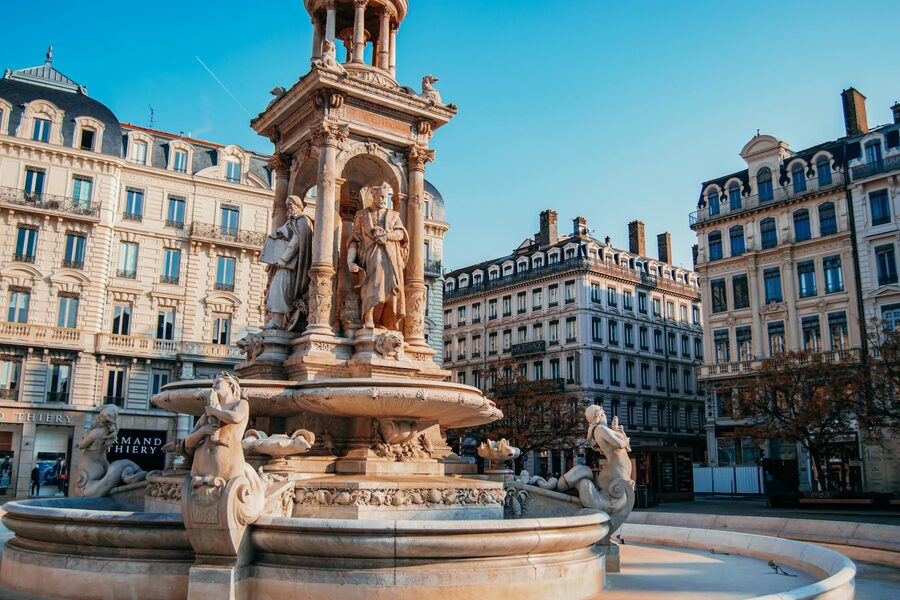 Ornate fountain at Place des Jacobins in Lyon with historic buildings