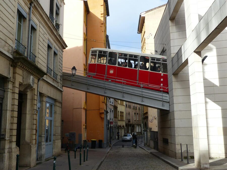 Aged red cable car funicular traveling through the old district of Lyon