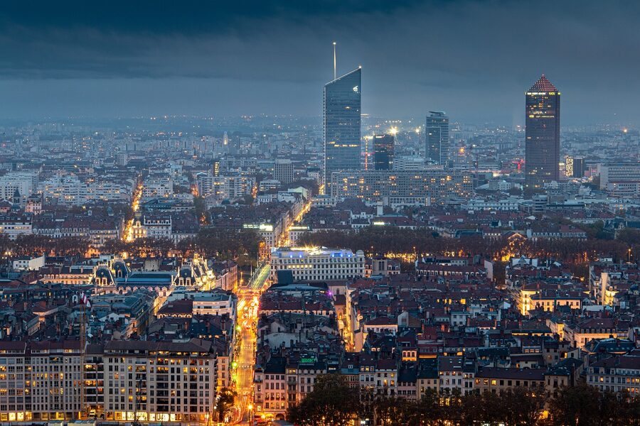 Lyon city skyline at night with the illuminated Fourviere basilica