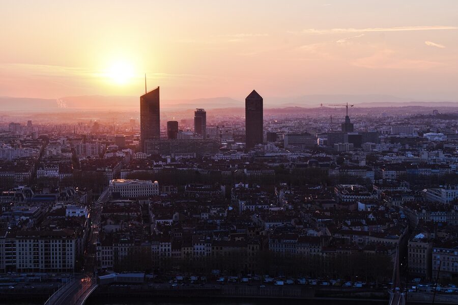 Sunrise over Lyon with lush green landscape and the city skyline