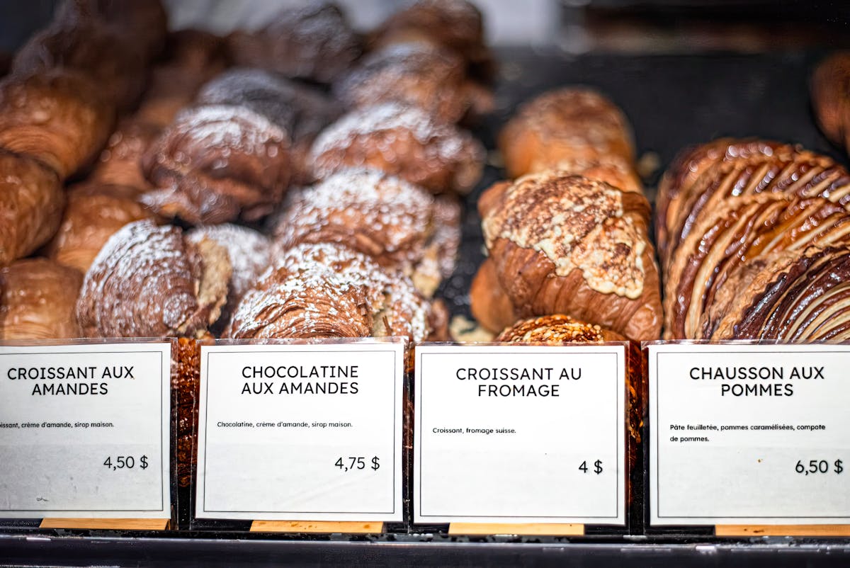Freshly baked French pastries displayed at a bakery counter