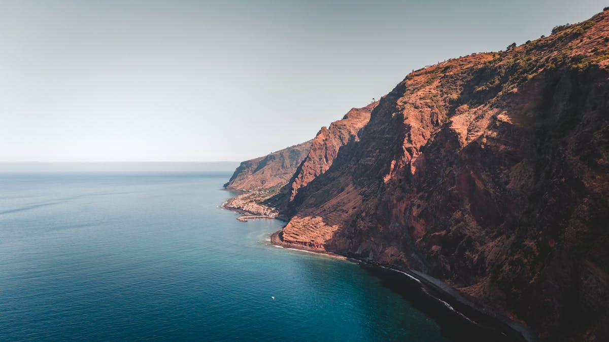 Rugged cliffs and deep blue ocean along Madeira Island
