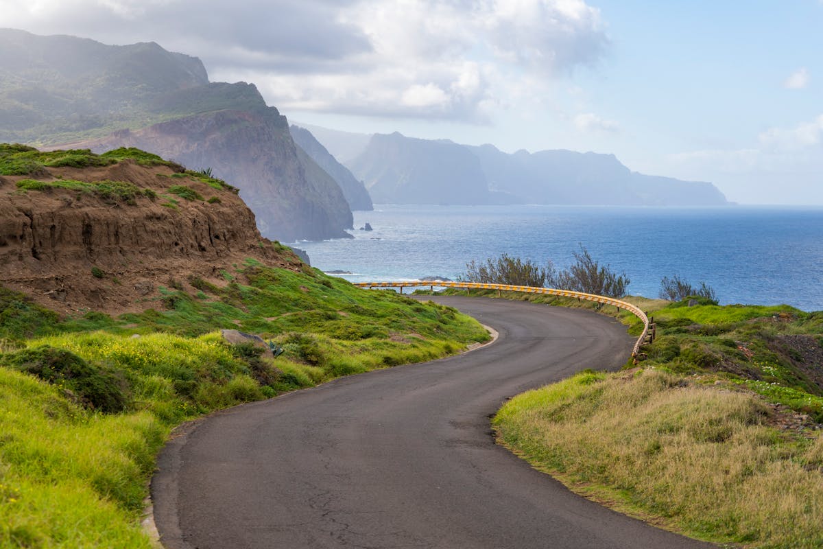 Winding road along the scenic coast of Madeira Island with ocean views