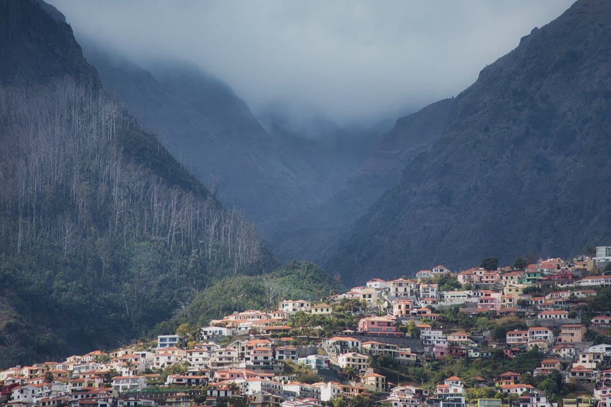 Picturesque mountain village in Madeira with lush green landscape and misty hills