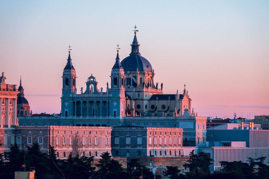 Almudena Cathedral in Madrid at sunset with golden sky
