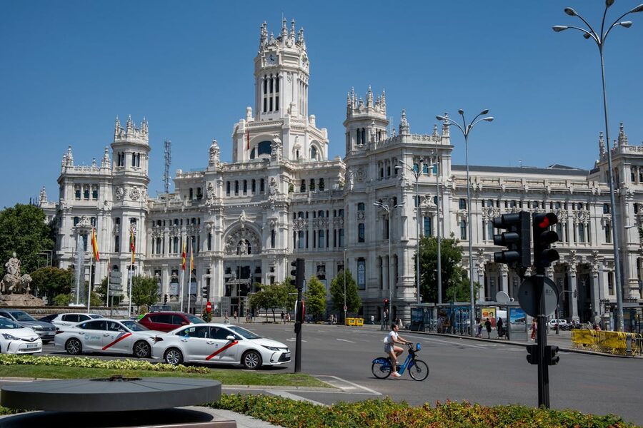 Cibeles Palace in Madrid with traffic and clear sky